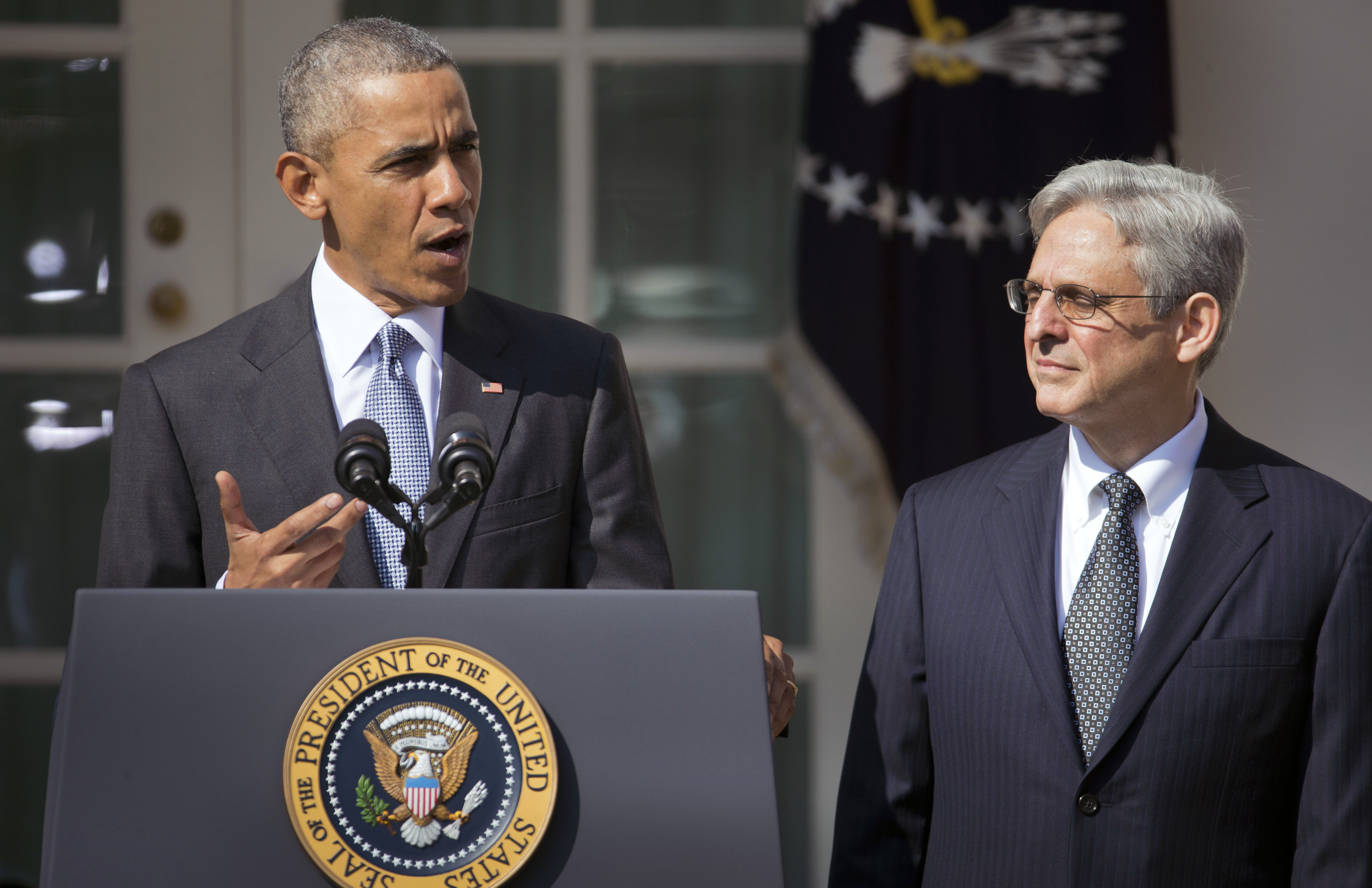 obama and supreme court nominee merrick garland at podium