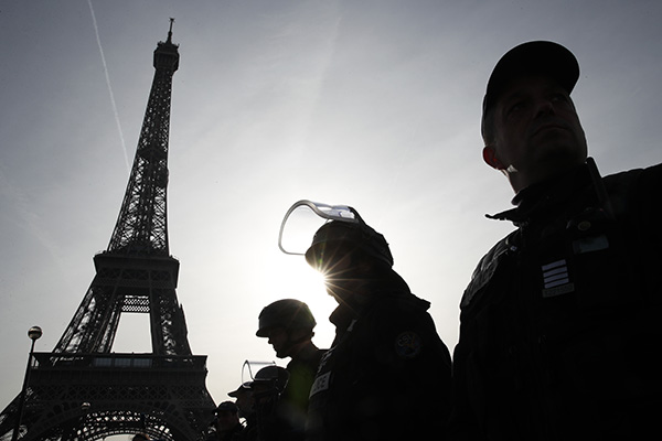 Police Officers Stand in Front of Eiffel Tower