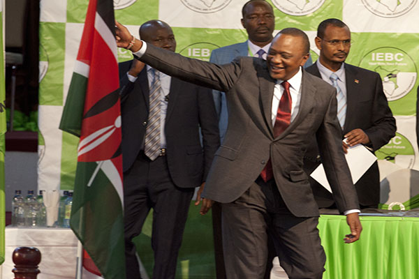 Kenyatta touches the Kenya flag when the results are announced