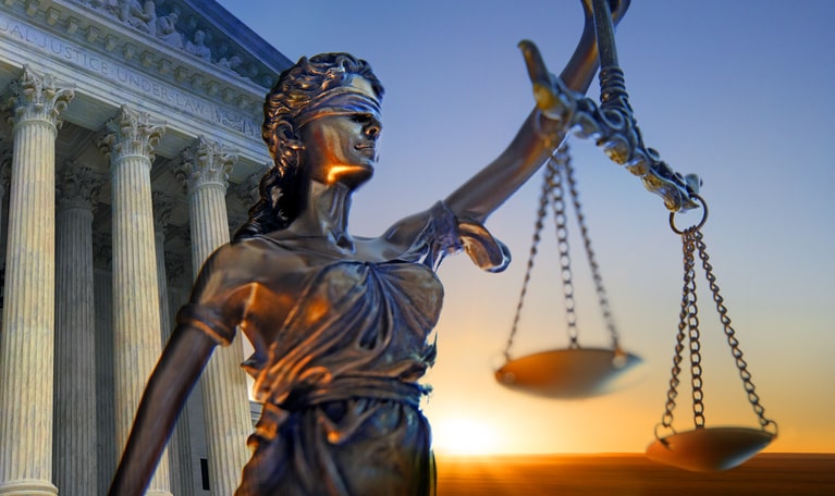 The figure of justice in front of a court 